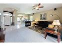 Inviting living room featuring neutral walls, tiled floors in entry and kitchen views at 1590 The Oaks Blvd, Kissimmee, FL 34746