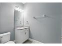 Clean powder room with a sleek vanity, large mirror, and modern fixtures at 168 Jensen Dr, Groveland, FL 34736