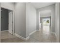 Inviting hallway featuring neutral paint, tile flooring, and easy access to the home's living spaces at 168 Jensen Dr, Groveland, FL 34736