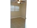 Bright bedroom featuring neutral paint, tile floors, and a ceiling fan at 2005 Kingsland Ave, Orlando, FL 32808