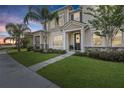 Inviting two-story townhouse with landscaped front yard, a welcoming entrance and a well-maintained lawn at 2151 Valencia Blossom St, Clermont, FL 34711
