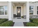 Welcoming front porch with decorative accents and a cozy seating area at 2151 Valencia Blossom St, Clermont, FL 34711