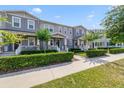 Attractive gray townhomes with manicured landscaping, covered porches, and inviting curb appeal at 2224 Celebration Blvd, Celebration, FL 34747