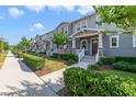 Street view of attractive townhomes featuring landscaped yards and inviting covered entries at 2224 Celebration Blvd, Celebration, FL 34747