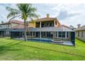 Exterior of a beautiful home featuring a large swimming pool, spa, and screened-in patio at 2333 Pinehurst Ct, Davenport, FL 33837