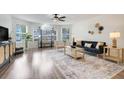 Spacious living room with a large arched window, stylish decor, and modern ceiling fan at 2743 N Poinciana Blvd # 55, Kissimmee, FL 34746