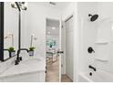 Modern bathroom featuring sleek white fixtures, a shower with dark hardware, and an elegant design at 304 W 24Th St, Sanford, FL 32771