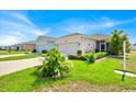 Beautifully landscaped front yard of this one-story home with well-maintained lawns and a concrete driveway at 3193 Whispering Trails Ave, Winter Haven, FL 33884
