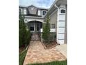 Home featuring decorative wrought iron gate, and attractive tiled front entryway at 3244 River Branch Cir, Kissimmee, FL 34741