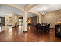 Open dining room features hardwood floors, stone accent wall, modern lighting, and seamless flow at 3759 Eagle Isle Cir, Kissimmee, FL 34746
