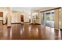 Inviting living area with hardwood floors, neutral paint, and seamless access to the outdoor patio at 3759 Eagle Isle Cir, Kissimmee, FL 34746
