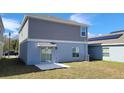 The back of the home, features a sliding glass door with access to the backyard at 443 Cool Summer Ln, Davenport, FL 33837