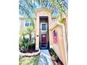 Close up of a charming entrance featuring a red front door and well manicured landscaping at 4447 Maple Chase Trl, Kissimmee, FL 34758
