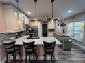 Open kitchen featuring stainless steel appliances, large island with bar seating, and updated cabinets at 4447 Maple Chase Trl, Kissimmee, FL 34758