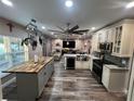 Spacious kitchen with stainless appliances, pendant lighting, and a seamless view into the living area at 4447 Maple Chase Trl, Kissimmee, FL 34758