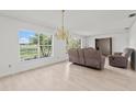 Bright living room featuring neutral walls, light-colored flooring, and large windows with scenic views at 4505 Kissimmee Park Rd, St Cloud, FL 34772