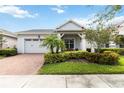 Charming single-story home with a two-car garage, landscaped front yard, and inviting front porch at 5025 Sunfalls Ave, St Cloud, FL 34772