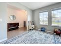 Cozy living room featuring tiled floors, a play area, and an abundance of natural light from large windows at 5712 Bristleleaf Ct, Leesburg, FL 34748