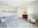Spacious living room area with a play area and neutral wall colors adjacent to the entryway at 5712 Bristleleaf Ct, Leesburg, FL 34748