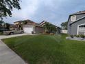 Well-maintained front yard featuring lush green grass and mature palm tree, with sprinkler system at 5921 Lake Champlain Dr, Orlando, FL 32829