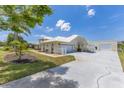 This property boasts a long drive and additional garage or workspace, all set on a lush lawn at 6555 Bay Tree Ct, St Cloud, FL 34771