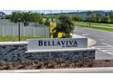 The BellaViva at Westside neighborhood sign in brick and stone with lush landscaping at 685 Overpool Ave, Davenport, FL 33896