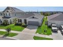 Inviting single-Gathering home with manicured lawn, a two-car garage and solar panels at 685 Overpool Ave, Davenport, FL 33896