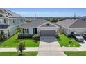 Inviting single-Gathering home featuring a well-manicured lawn and two-car garage at 685 Overpool Ave, Davenport, FL 33896