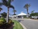 Attractive clubhouse with a white roof, landscaping, and palm trees providing a resort style feel at 8101 Coconut Palm Way # 303, Kissimmee, FL 34747