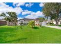 Charming single-story home featuring a lush, well-manicured front yard and an attached two-car garage at 812 Adour Dr, Kissimmee, FL 34759