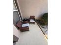 Cozy patio space with comfortable wicker chairs, perfect for relaxing outdoors at 939 Jaybee Ave, Davenport, FL 33897