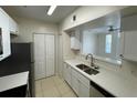 Modern kitchen featuring stainless steel appliances, white cabinets, and open view into living area at 1020 Siena Park W Blvd # 304, Kissimmee, FL 34747