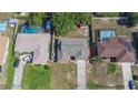Aerial view of a single-story home with a grey roof, concrete driveway, and proximity to neighboring properties at 1022 Blue Horizon Dr, Deltona, FL 32725