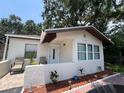 Inviting single-story home featuring a quaint front patio and neatly arranged landscaping at 1101 28Th Nw St, Winter Haven, FL 33881