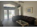 Inviting living room with sliding glass doors leading to a private pool area at 123 S Roma Way, Kissimmee, FL 34746