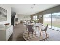 Open-concept living room features modern decor, wood floors, stairs, and natural light from sliding glass door at 1404 Axel Cir, Winter Haven, FL 33880