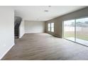Spacious living room features wood floors, ample natural light, and access to the backyard through sliding glass door at 1404 Axel Cir, Winter Haven, FL 33880