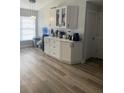 Bright kitchen with lots of counter space, white cabinets, stainless steel appliances, and wood-style floors at 1427 Orchid Ln, Kissimmee, FL 34744