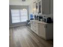 Bright kitchen featuring white cabinets, modern countertops, stainless steel appliances, and wood-style flooring at 1427 Orchid Ln, Kissimmee, FL 34744