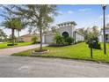 Charming single-story home with well-manicured lawn, mature trees, and paver driveway at 1703 Encinitas Way, Kissimmee, FL 34759