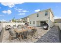 Entertain in a spacious backyard patio furnished with dining and lounge seating at 1765 Petiole Pl, Kissimmee, FL 34744
