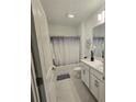 Bright bathroom featuring a shower-tub combination and a single sink vanity at 200 Citrine Loop, Kissimmee, FL 34758