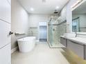 Spa-like bathroom with a soaking tub, walk-in shower, and modern vanity with a vessel sink at 2000 Greenbriar Ter, Davenport, FL 33837