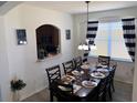 Charming dining area with seating for eight, complemented by elegant decor and natural light at 2514 Dharma Cir, Kissimmee, FL 34746