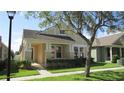 Inviting curb appeal, featuring a covered porch with stately columns and a landscaped front yard at 2673 Rainbow Springs Ln, Orlando, FL 32828