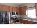 Well-appointed kitchen with granite countertops, stainless steel appliances, and ample cabinet space at 2673 Rainbow Springs Ln, Orlando, FL 32828