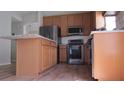 Spacious kitchen featuring stainless steel appliances, granite countertops, and a breakfast bar at 2673 Rainbow Springs Ln, Orlando, FL 32828