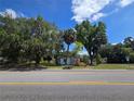 Charming property showcasing home with mature trees and a well-maintained lawn at 2704 Sample St, Kissimmee, FL 34744