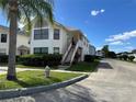 Exterior elevation of a two-story townhome with a private entrance and well-maintained landscaping at 2734 Rio Grande Trl # 2734, Kissimmee, FL 34741