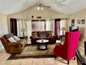 Comfortable living room with vaulted ceilings, ceiling fan, plush seating, and natural light at 2734 Rio Grande Trl # 2734, Kissimmee, FL 34741